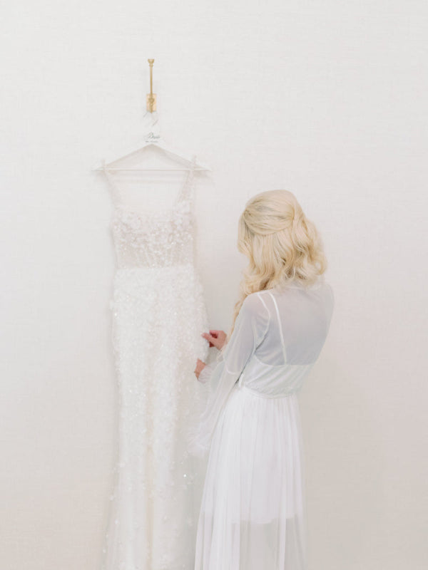 Bride admires her wedding dress