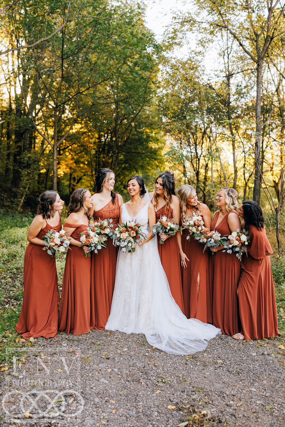 Bridal party wears burnt orange bridesmaid dresses