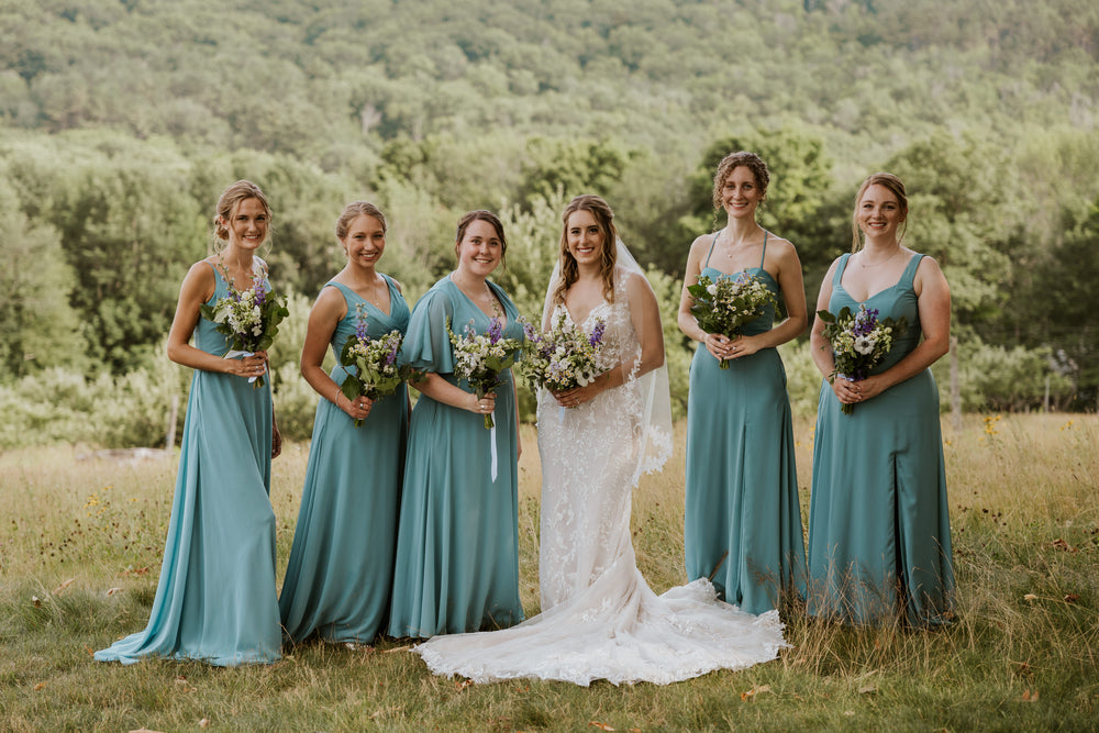 Bridal party wears deep sea bridesmaid dresses