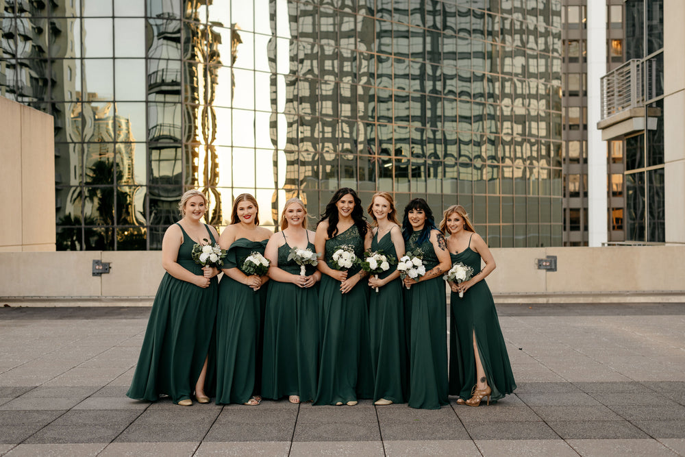 Bridal party wears emerald bridesmaid dresses