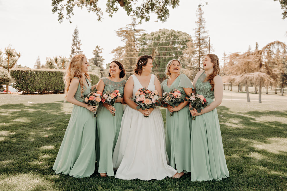 Bridal party wears sage green bridesmaid dresses